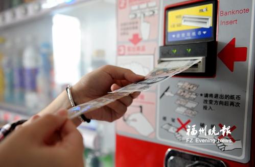 纸币粘上胶带“掏空”售货机? 记者亲测不可行